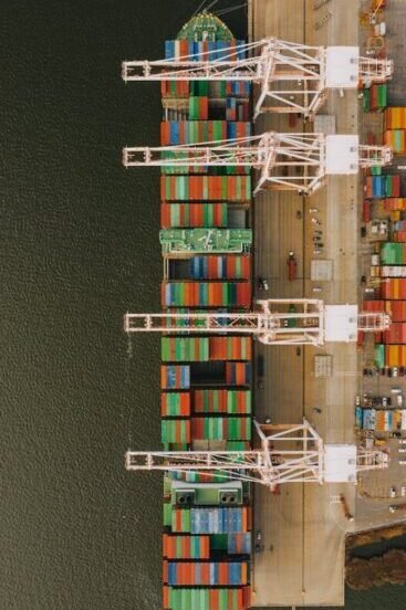 Overhead shot of colorful cargo containers and cranes at Baltimore's bustling port.